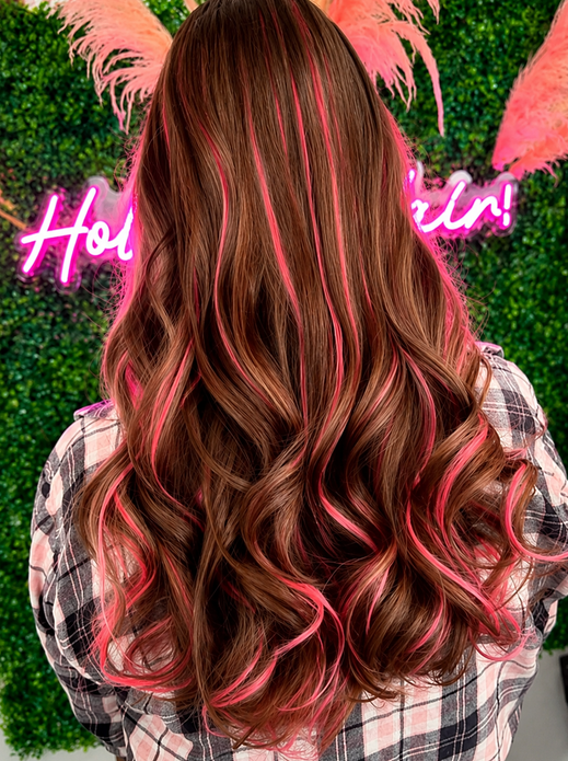 Brown hair extensions with bright pink highlights and loose curls 